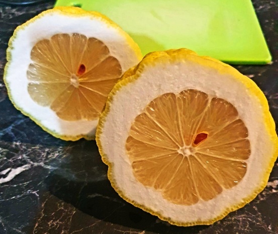 Close-up of a thick-skinned lemon variety with substantial flesh, commonly found in Azerbaijan, displayed to show its distinctive size and texture
