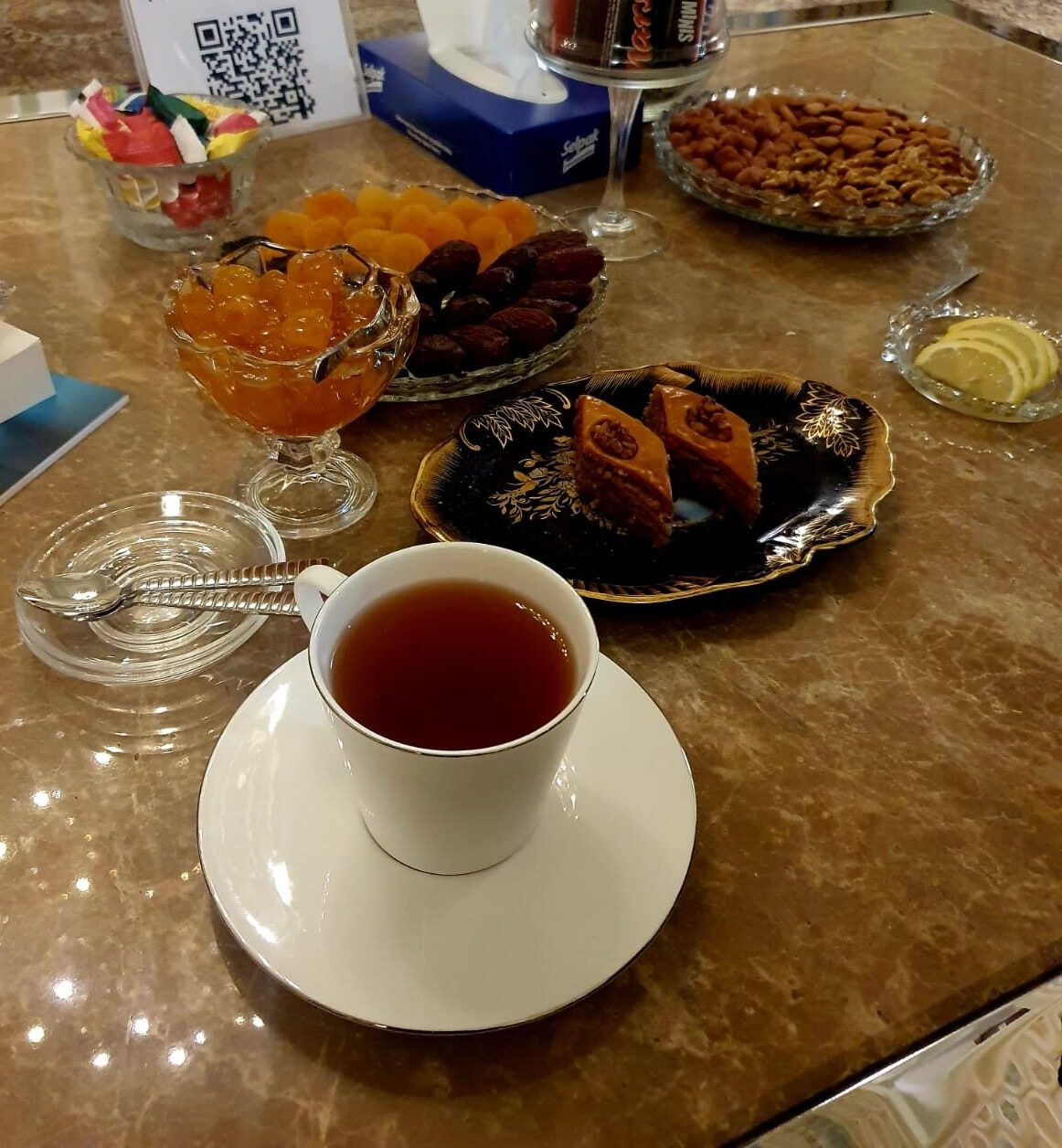 Traditional Azerbaijani hospitality spread at the VIP lounge of Baku Railway Station, featuring tea, pakhlava, candies, nuts, and various sweets