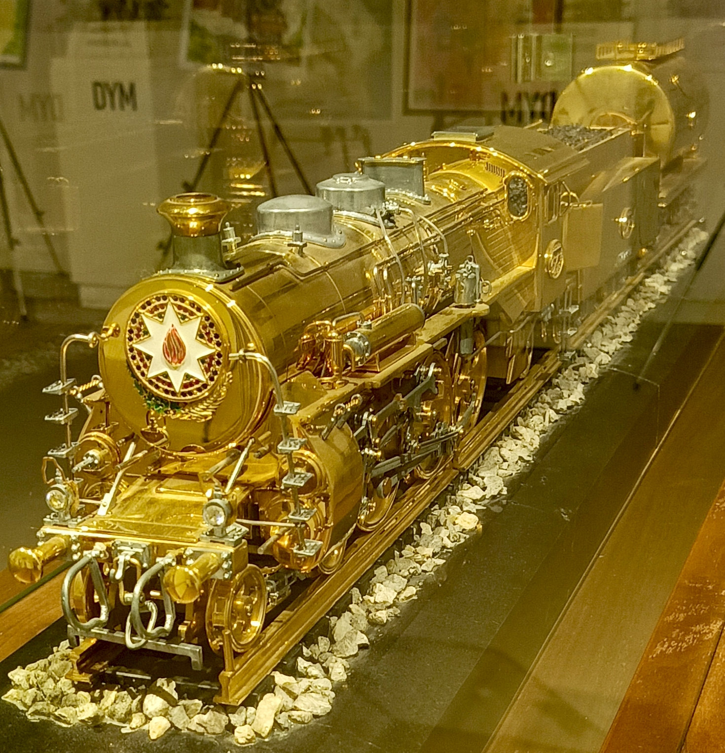 A gold-colored locomotive on display at the Azerbaijan Railway Museum in Baku