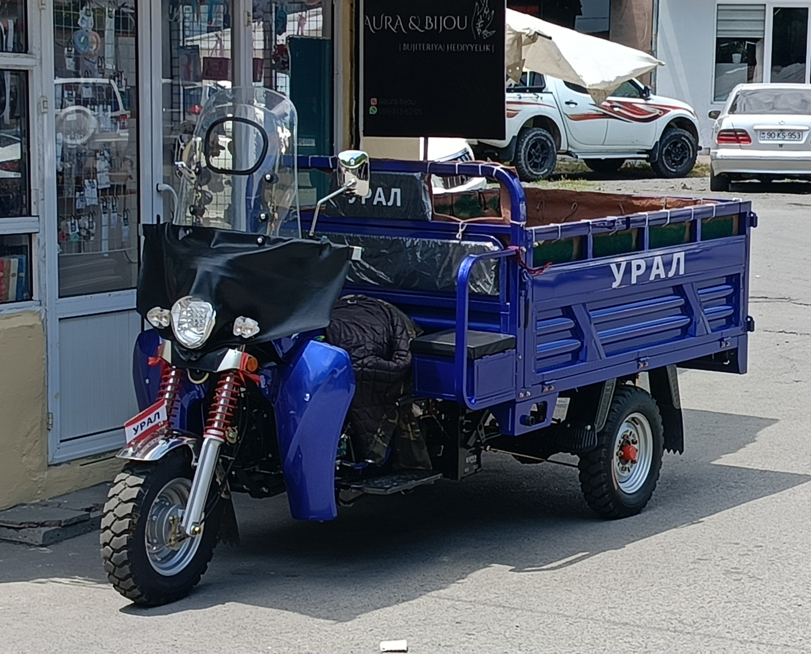 A three-wheeled cargo cycle used for transporting goods in Azerbaijan, a practical vehicle commonly seen at markets and for local deliveries